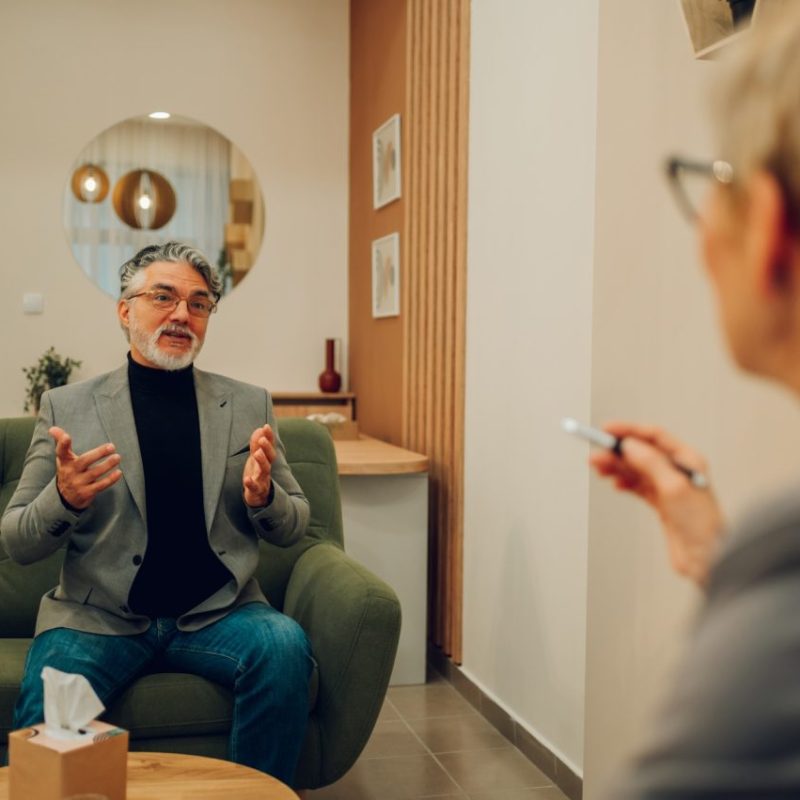 a-mature-man-in-crisis-is-discussing-trauma-with-a-psychotherapist